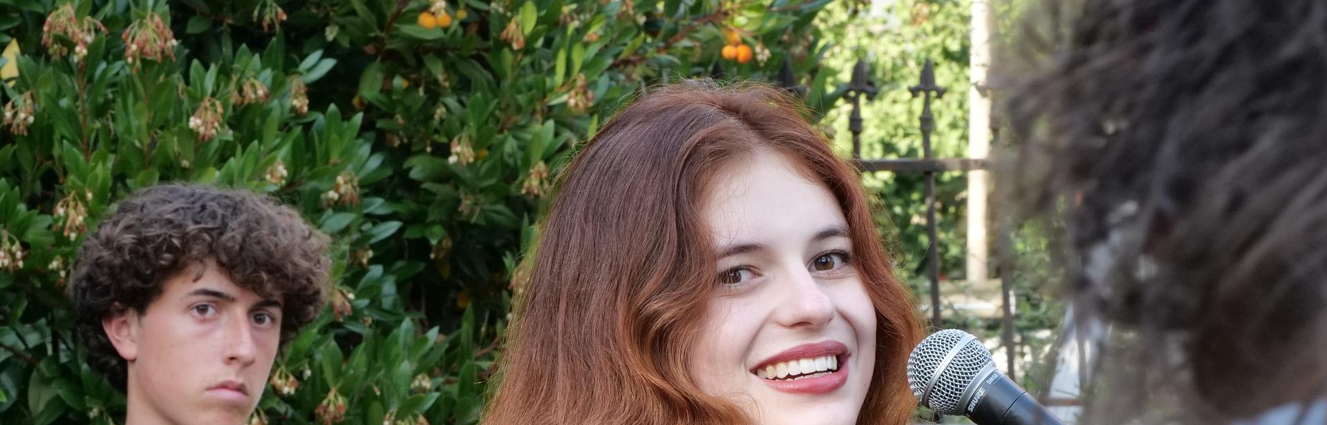 Student smiling at teacher during rehearsal