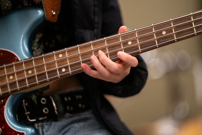 Hands on the bass guitar